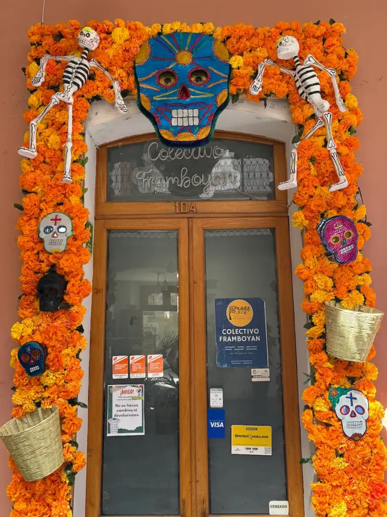 Oaxaca City Day of the Dead street decorations - Andador turistico shop front flowers and skulls